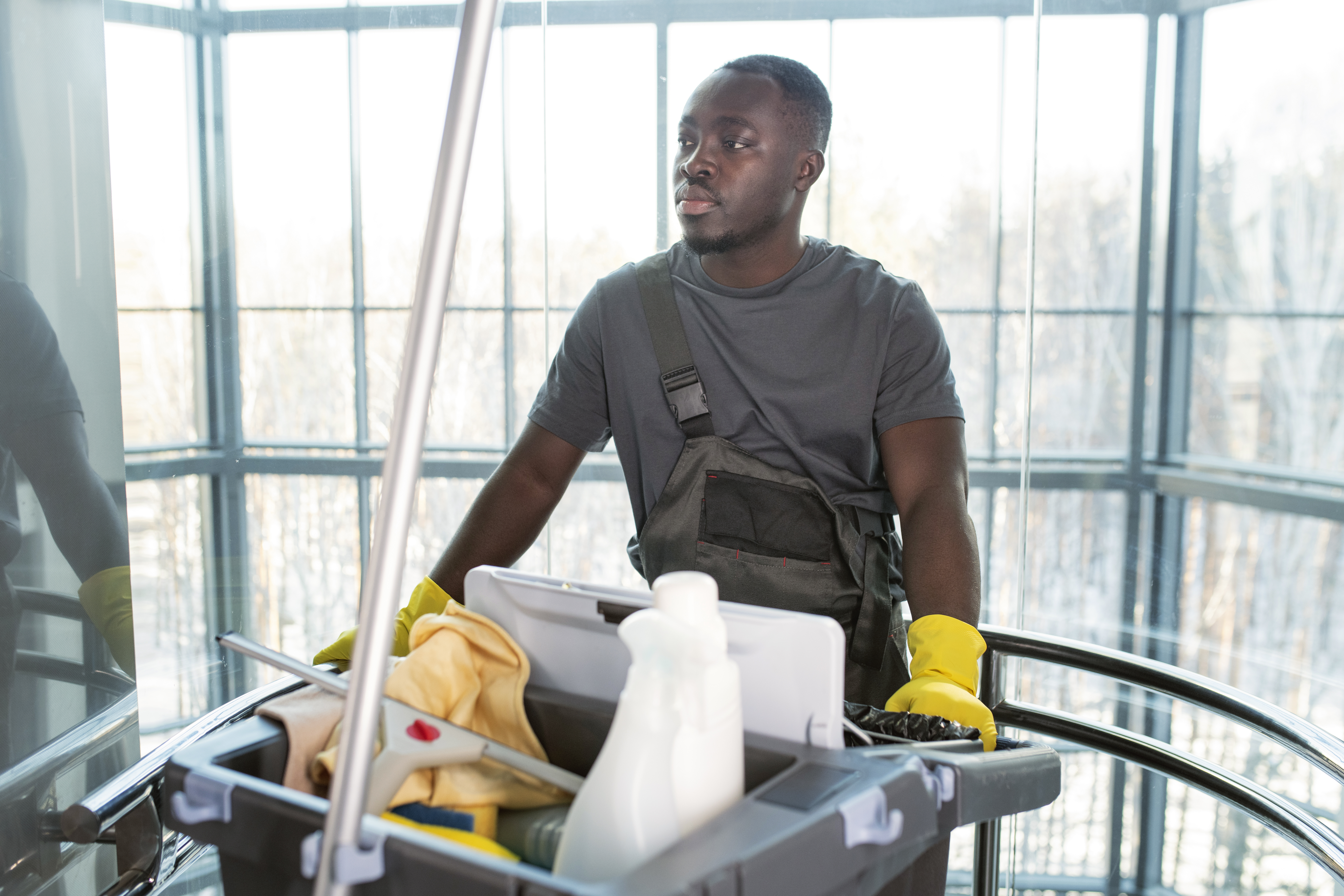 medium-shot-man-walking-with-cleaning-cart